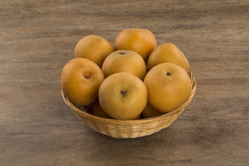 Some asian pears over a wooden surface