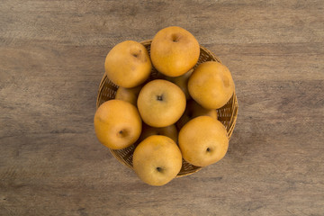 Some asian pears over a wooden surface