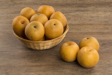 Some asian pears over a wooden surface