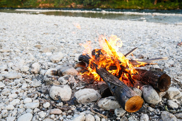 Self-made campfire by the mountain river
