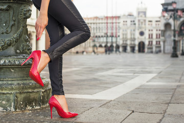 Fototapeta na wymiar Beautiful legs with red high heel shoes