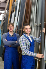 Happy workmen near PVC window frames