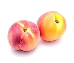 Two ripe peach on a white background