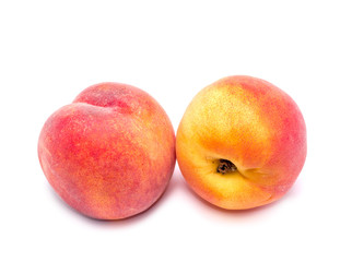 Two bright juicy peach on a white background