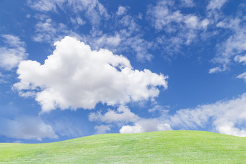 Sky and cloud over green grass hill