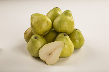 Some pears in a basket over a wooden surface seen from above