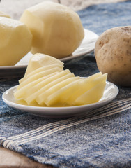 sliced raw potato on kitchen table