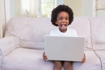 Little boy using a laptop 