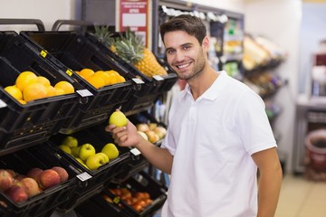 Portrait of a handsome man buying a fruits
