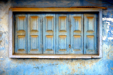 old shuttered blue windows