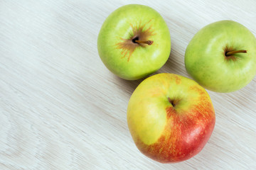 two green apples and red apple, top view