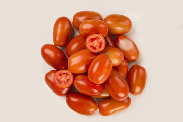 Some tomatoes over a wooden surface on a tomato field as backgro