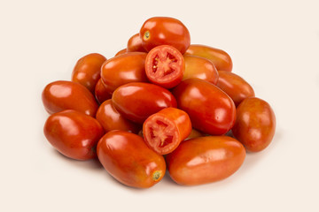 Some tomatoes over a wooden surface on a tomato field as backgro