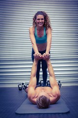 Muscular couple doing core exercises