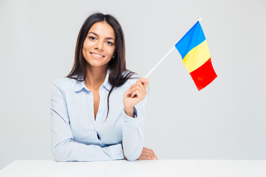Woman sitting at the table with romanian flag