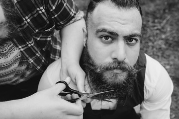 two bearded men shave