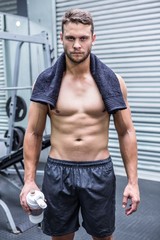 Portrait of muscular man looking at camera in crossfit gym