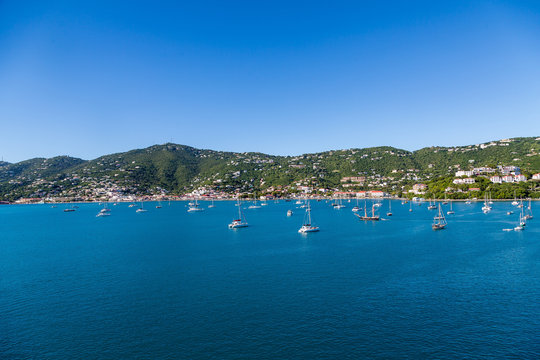 White Sailboats Moored in Blue Bay by Green St Thomas