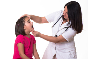 Female doctor examining child with tongue depressor at surgery