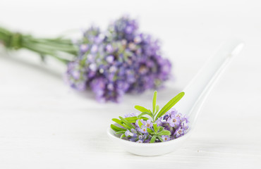 Wellness treatments with lavender flowers on wooden table. Spa still-life.