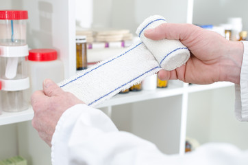Doctor holding a roll bandage