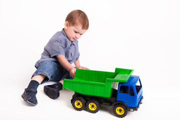 Boy is playing with truck