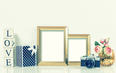 Golden picture frames, roses flowers and vintage camera. Retro s