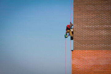 Steeplejack Builder worker plastering industrial building facade