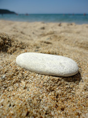 Fototapeta na wymiar Stone on sandy beach