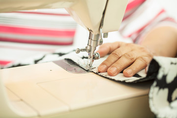 Close up of woman sewing on sewing machine