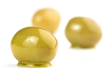 close up of green olives isolated on white
