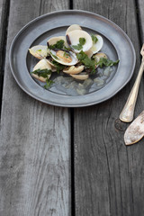 White clamshells with wine and parsley sauce.