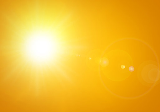 bright sun with lens flare in orange background