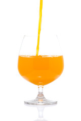 Orange Juice Pour into Wine Glass on White background