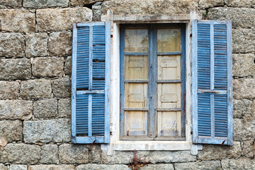 Old window with blue open shutters