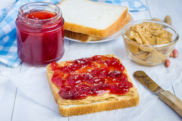 Sandwich with creamy peanut butter and strawberry jam