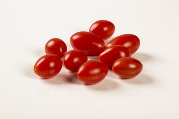 A bowl of grape tomatoes over a wood table
