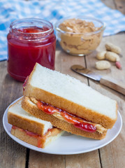 Sandwich with creamy peanut butter and strawberry jam