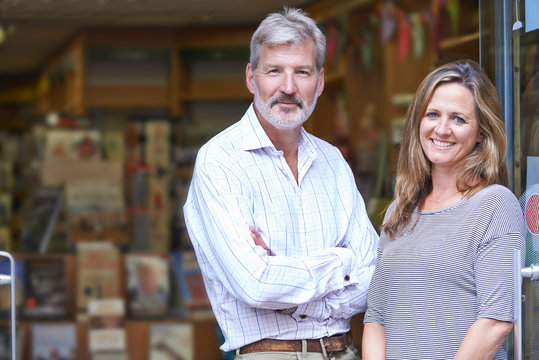 Portrait Of Couple Who Own Bookshop Outside Store