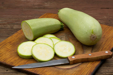 Zucchini and knife on a cutting board