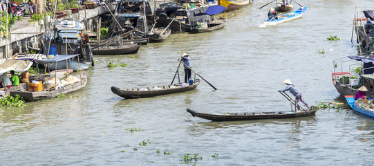 Mekong River, Hau Giang, Vietnam - April 6, 2015: Scenes of women rowing freight, bringing people across the river into the market early on Mekong river, Can Tho, Vietnam