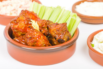 Buffalo Wings - Hot and spicy buffalo chicken wings with celery and cheese dip.
