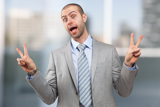 Man doing victory sign with both hands