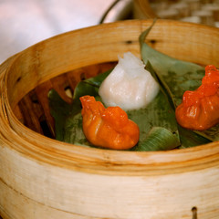  Cantonese cuisine. Dim sum cooked in steamer baskets.