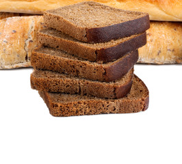 Sliced rye bread and two loaves of wheat flour