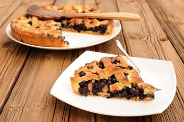 Homemade fresh lattice pie with whole wild blueberries cut in pi
