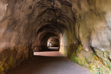 Tunnel in the mountain with a footpath, stretching into the distance. Diminishing perspective....