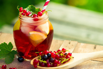 Red currant drink on wooden table