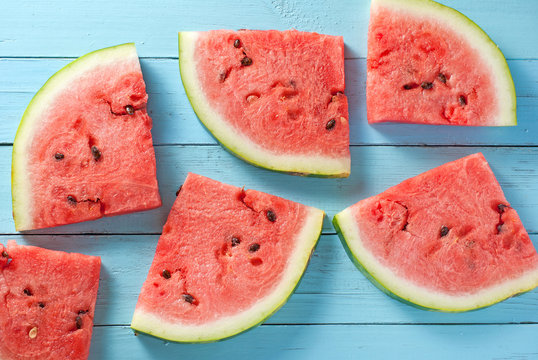 Watermelon slices on blue wood backdrop