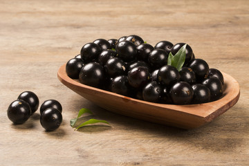 Berry Jaboticaba in bowl on wooden table